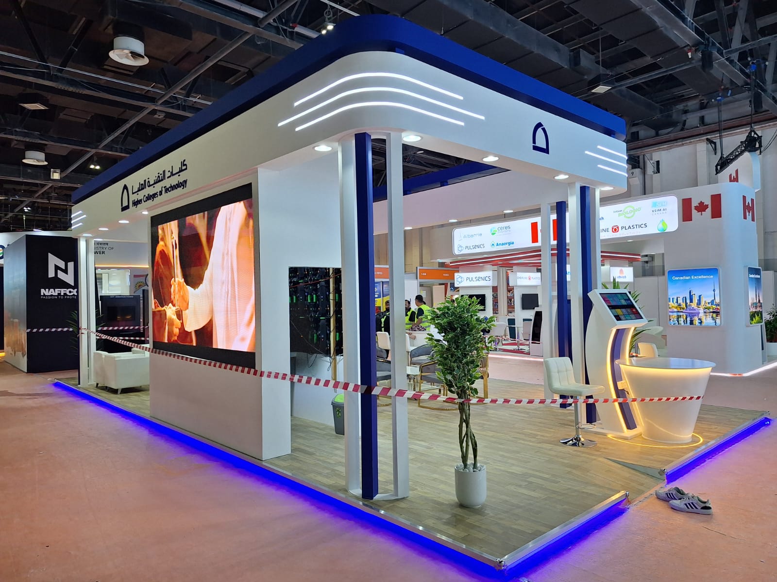 HCT exhibition stand with digital screens and branded counters