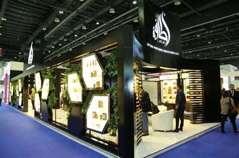 Luxury cosmetic exhibition stand at Beautyworld Middle East DWTC with brushed gold trim, fluted glass, and illuminated display vitrines